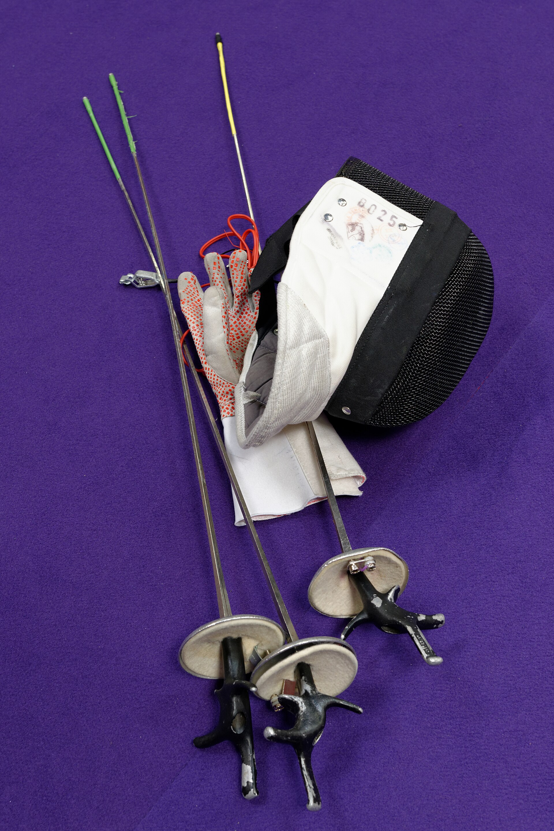 Two fencers shaking hands after a bout