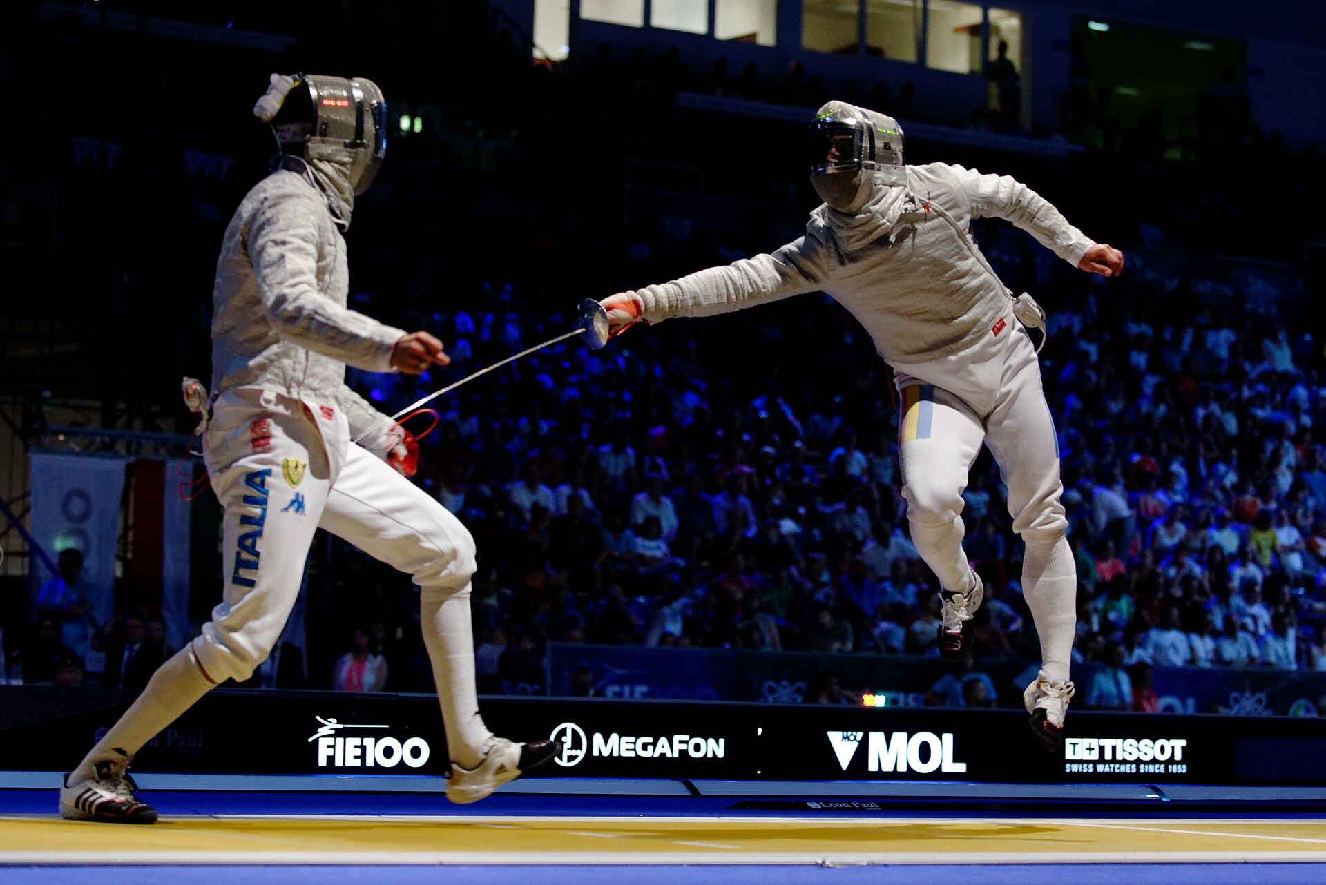 Two sabre fencers mid-attack during a competition bout