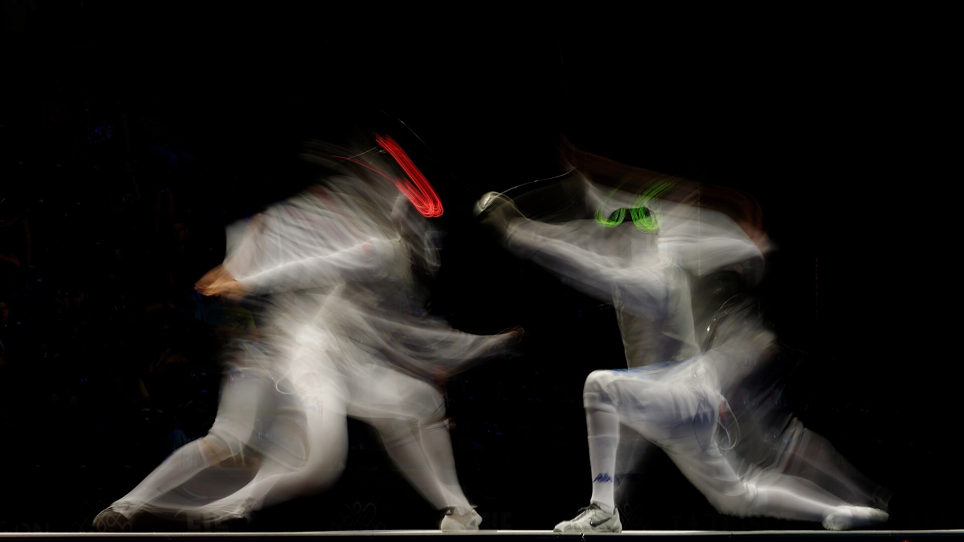 Two fencers in a team final bout on the piste